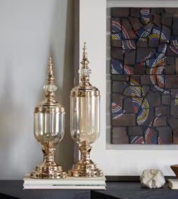 CosmoLiving by Cosmopolitan Gold Metal Decorative Jars with Finial Lids (Set of 2)